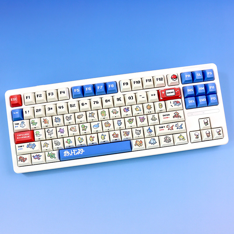 White TKL keyboard with retro ruby and sapphire cherry profile pixel art keycaps and blue accents.
