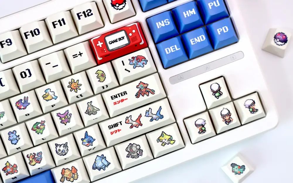 White keyboard with retro ruby and sapphire cherry profile pixel keycaps featuring red Game Boy and blue nav keys.