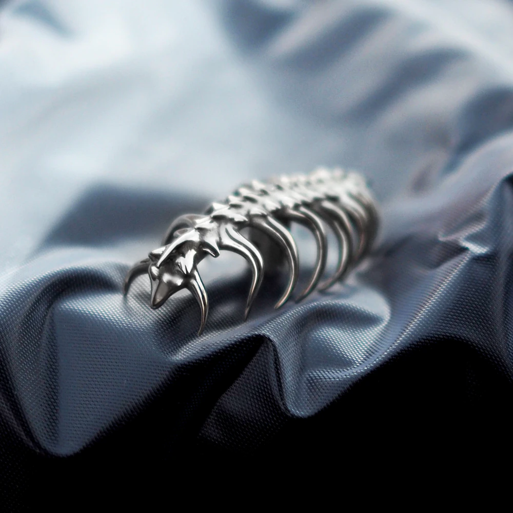 Sci-Fi Creature Keycap on Folded Fabric Handmade copper keycap sculpted as a ribbed creature displayed on wavy fabric.