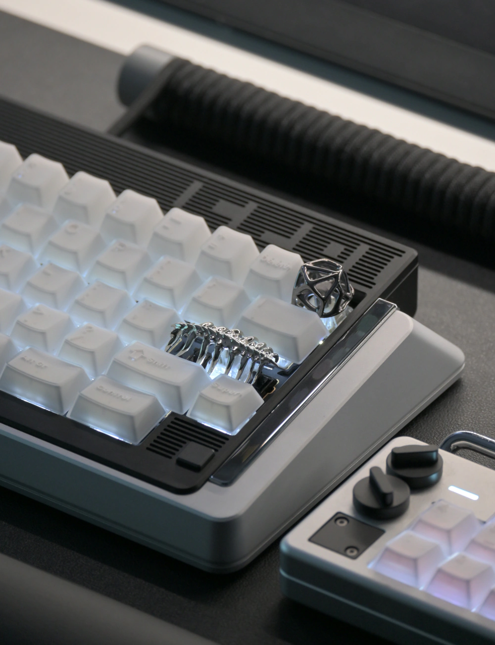 Sci-Fi Creature Keycap Keyboard View Silver creature keycap on a compact keyboard with white backlit keycaps.
