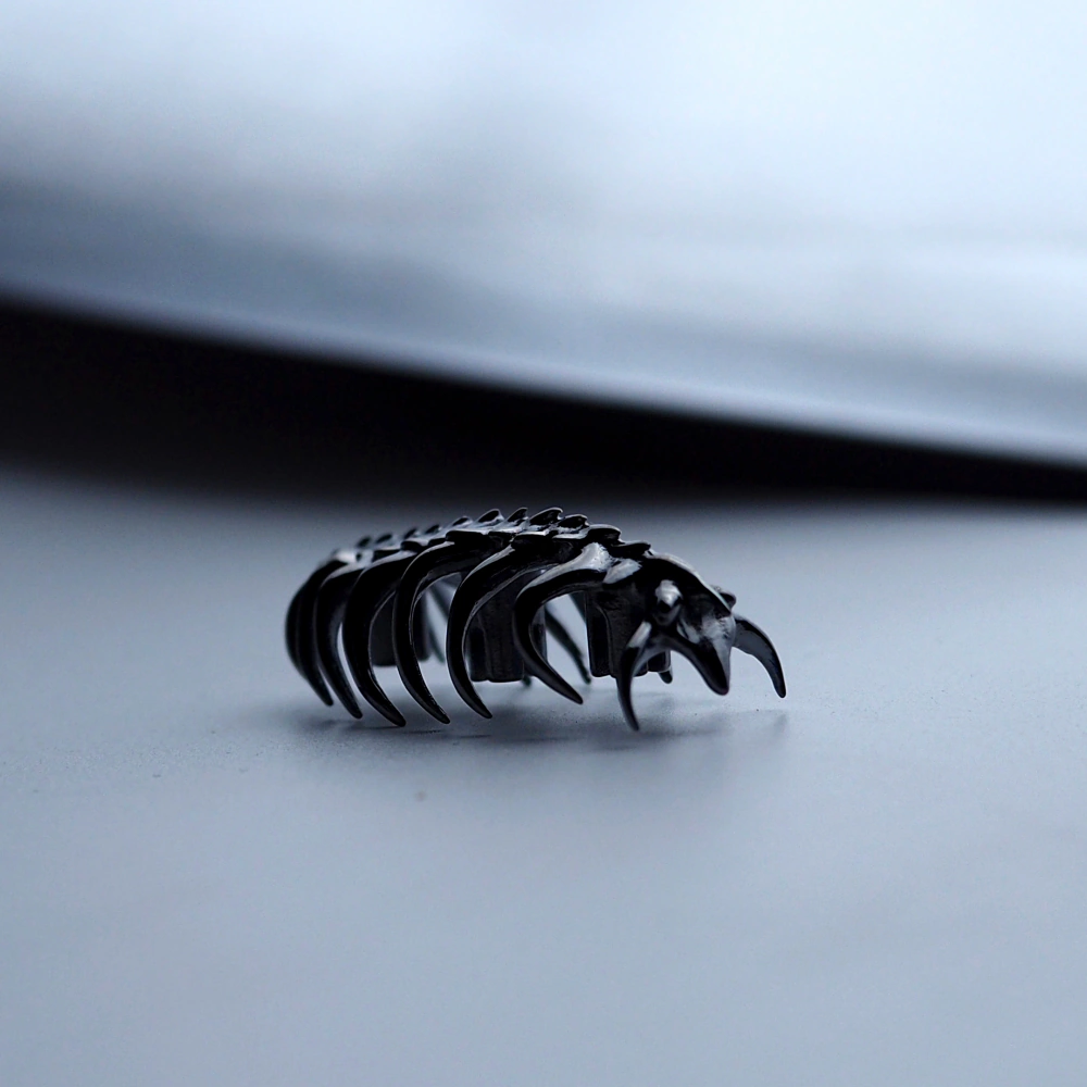 Sci-Fi Creature Keycap Low Angle Macro Handmade copper keycap in creature form captured from a low macro angle on gray desk.