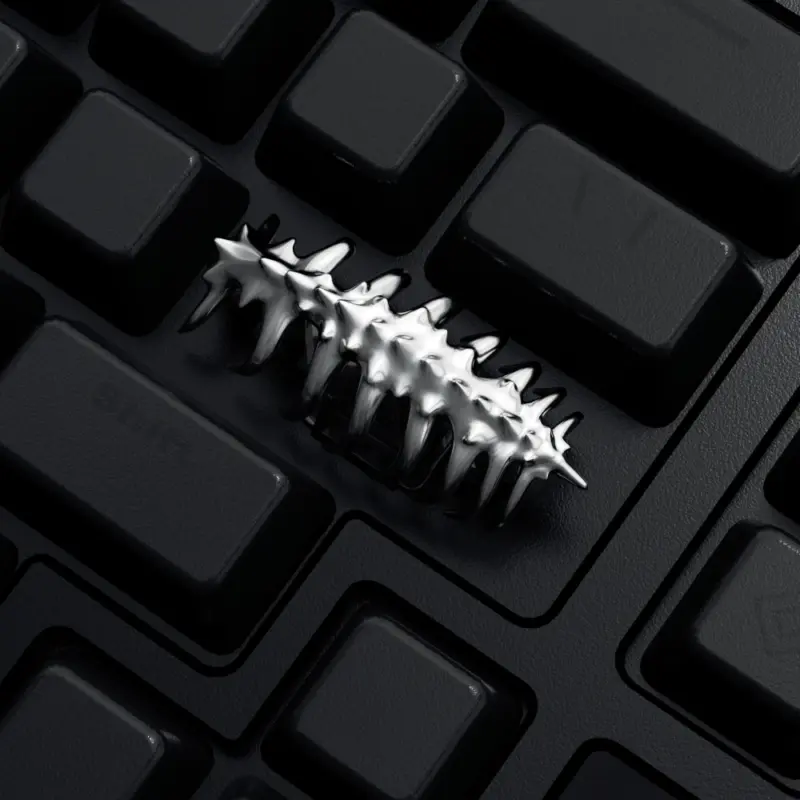 Sci-Fi Creature Silver Keycap Close Up Close-up of a silver creature shaped keycap installed on a black keyboard.