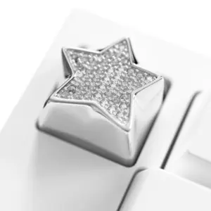 Sparkling Star Diamond Metal Keycap Macro Shiny star keycap featuring an electroplated platinum finish and cubic zirconia stones on a white keyboard.