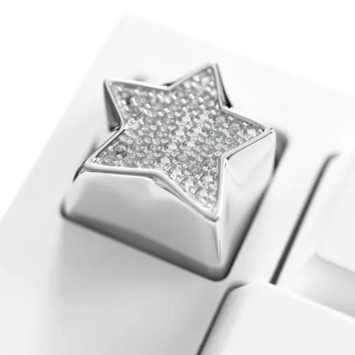 Sparkling Star Diamond Metal Keycap Macro Shiny star keycap featuring an electroplated platinum finish and cubic zirconia stones on a white keyboard.