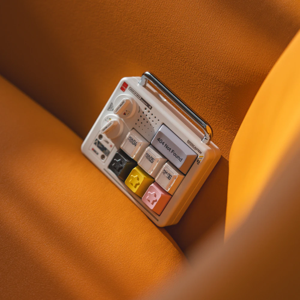 Star keycaps shown from the side on a compact display against orange fabric.