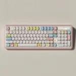 Full keyboard fitted with Cozy Journal keycaps, including pastel pink, blue, and yellow accents.