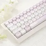 Cute Cat Afternoon Tea Keycaps Left Angle View Pink and white keycaps with cat, dessert, and teacup icons on a white keyboard