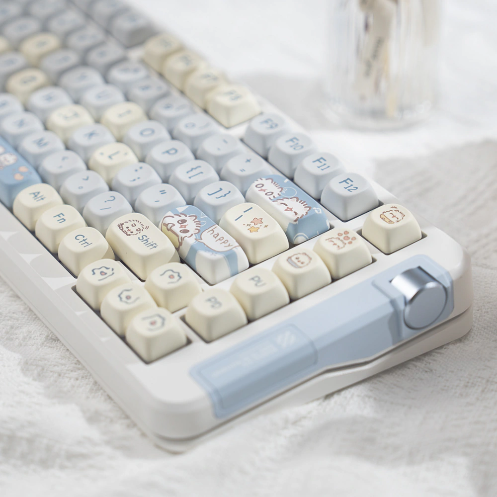 Angled right view of rounded pastel cat keycaps on a white and blue keyboard
