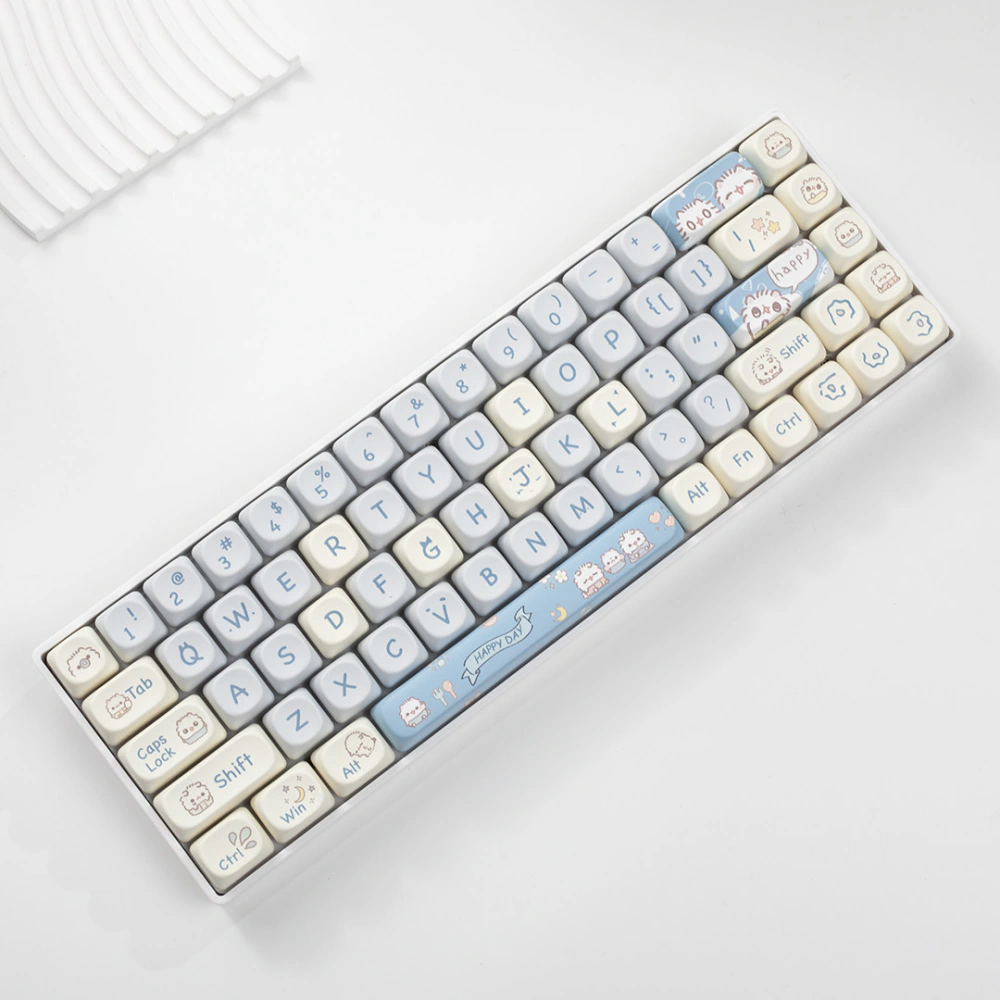 Compact keyboard wearing pastel blue cream and gray keycaps with cat illustrations