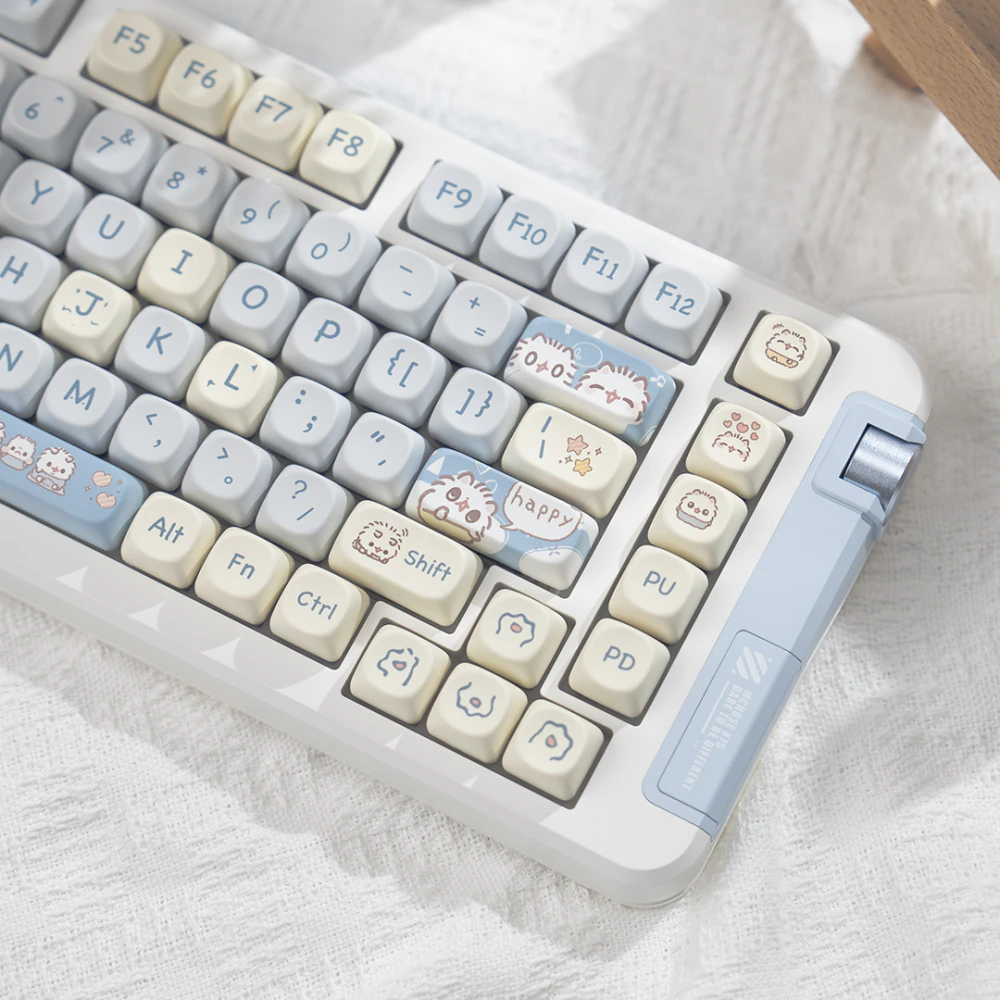 Right side key cluster with blue cat accents cream arrow keys and a metal colored knob