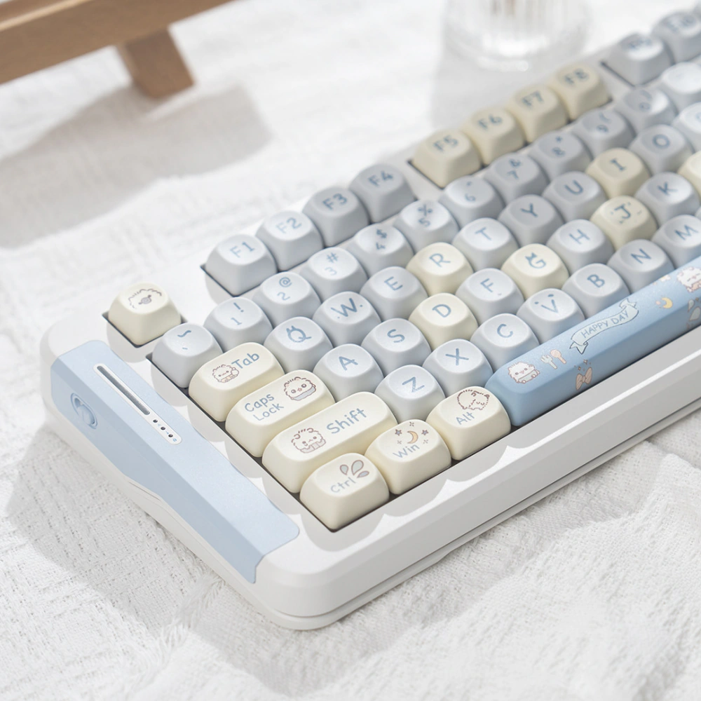 Left corner view of pastel blue cream and gray cat keycaps on a keyboard