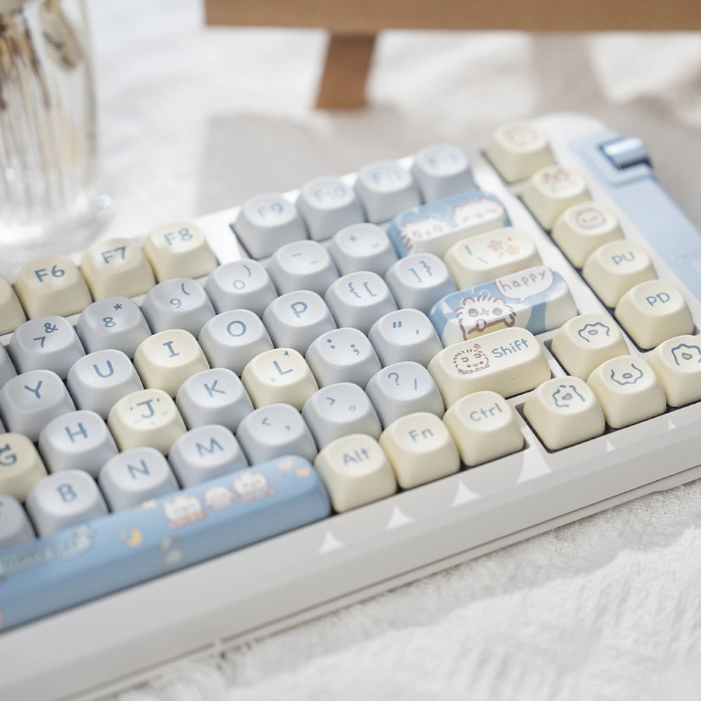 Close view of gray and cream keys with cat art on Shift and blue accent keys