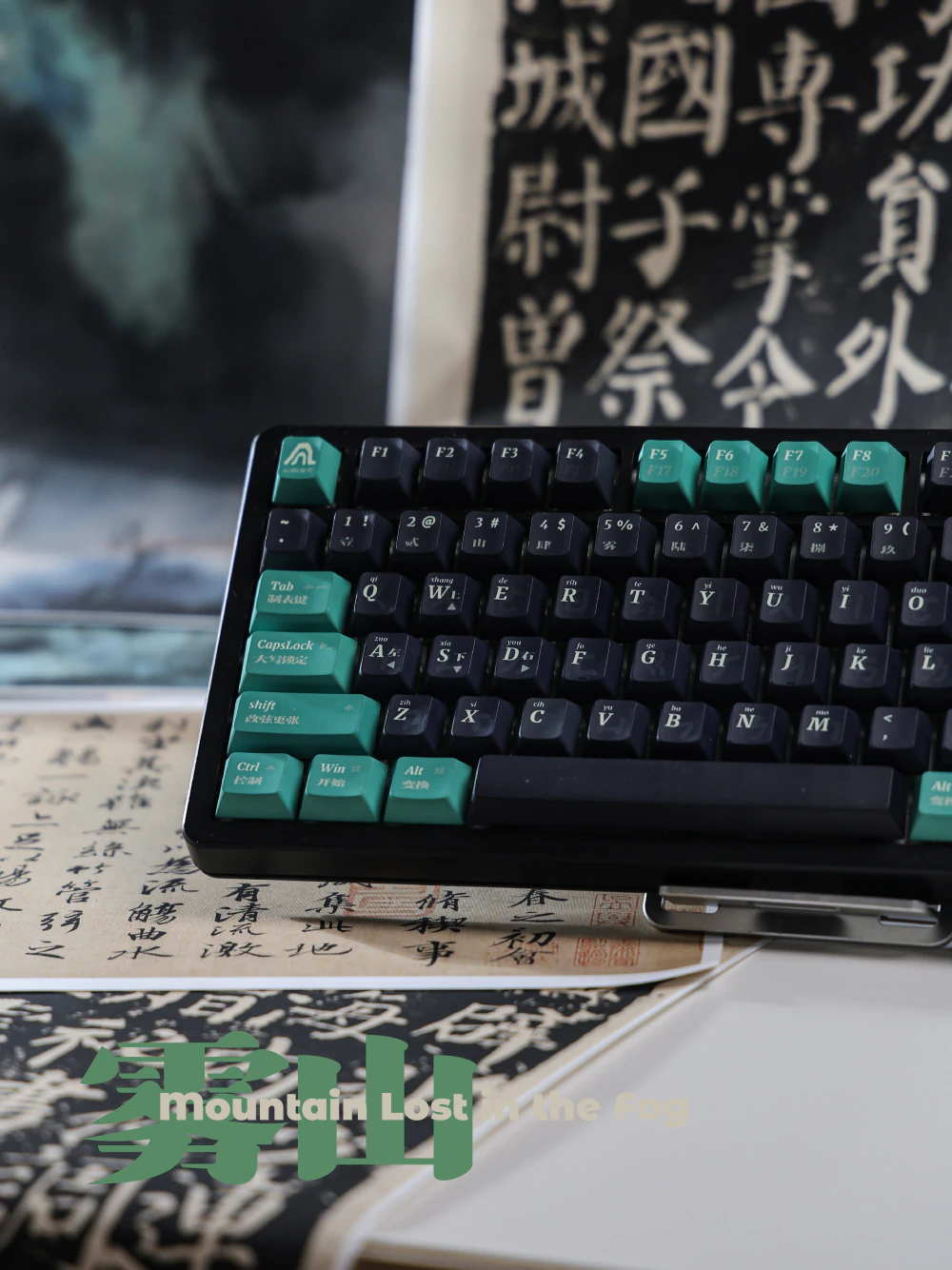 Front view of dark and sea-green keyboard keycaps on calligraphy-covered books.