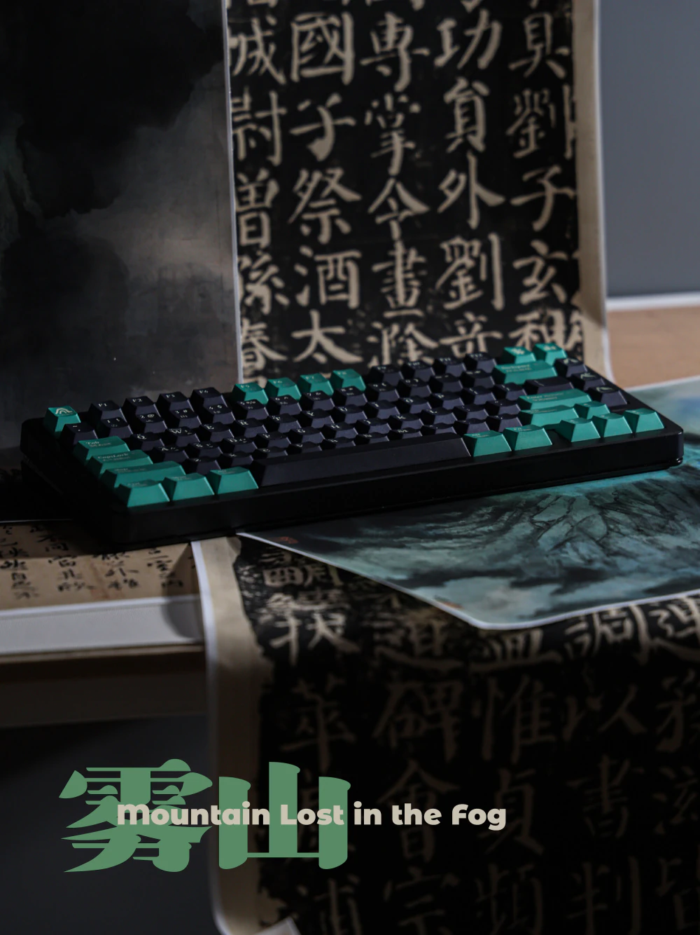Full black keyboard with dark keys and sea-green modifiers against Chinese calligraphy.