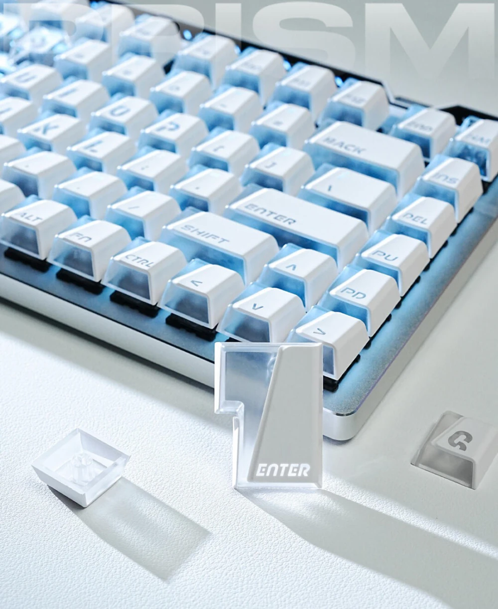 White Prism keycaps on a keyboard with a loose Enter key and blue light between keys