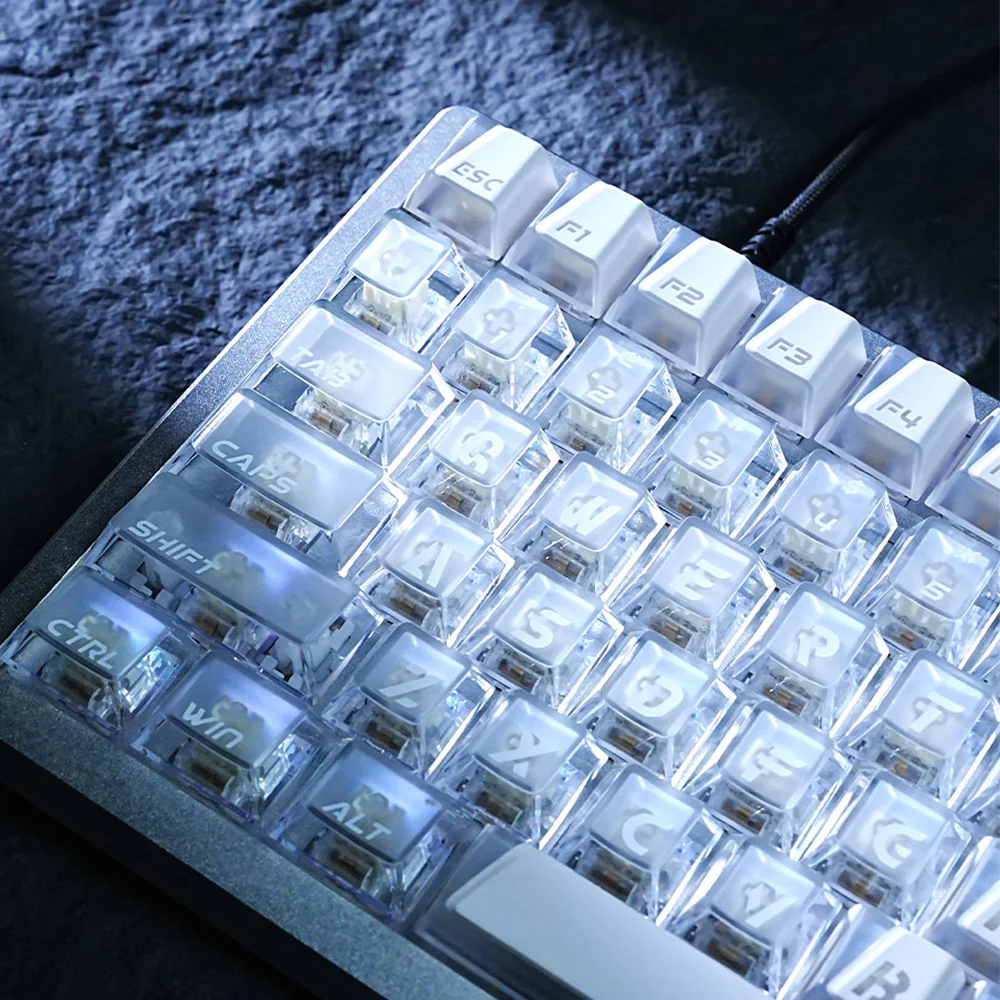 White Prism keycaps close-up showing clear lower structure and pale legends