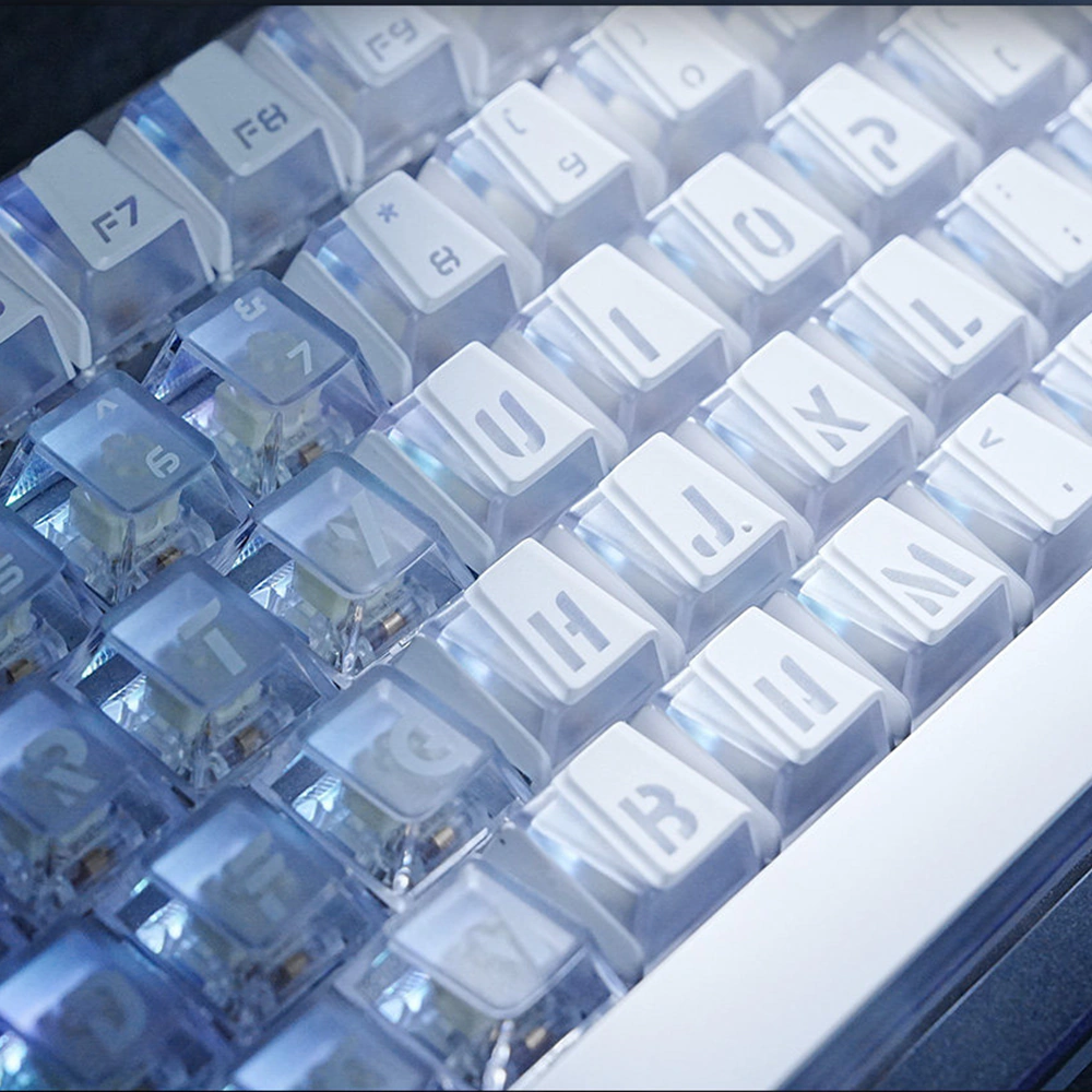 White Prism keycaps shown close up with blue light through the key gaps