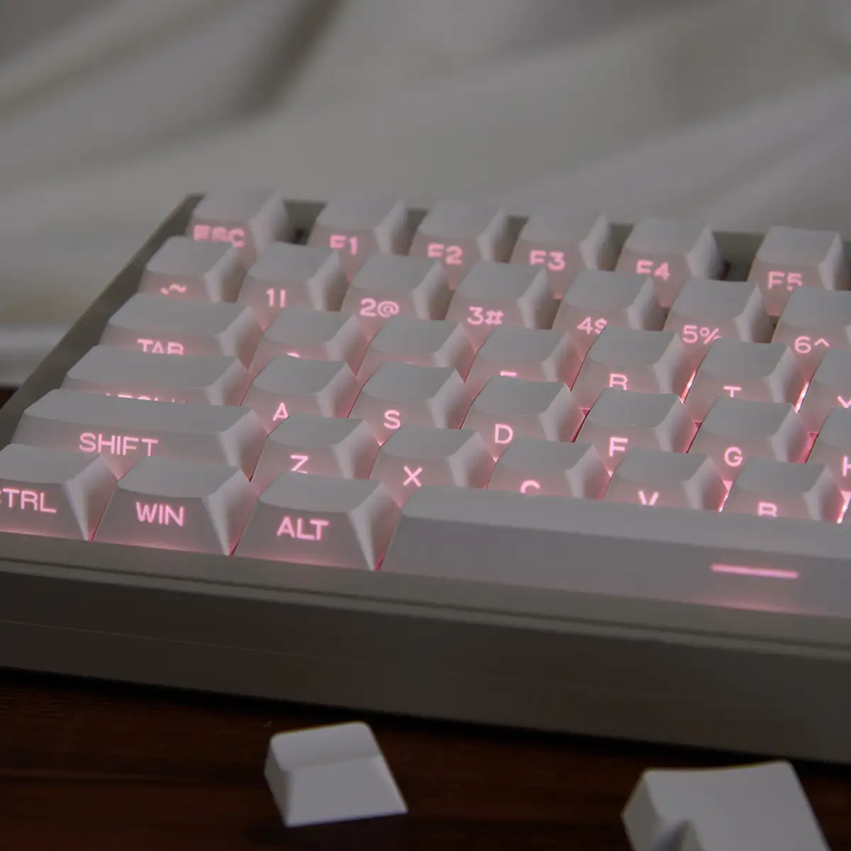 Shine-Through Keycaps in 2026: Classic and Modern Designs White side-lit keycaps with pink RGB glowing through legends and keycap gaps