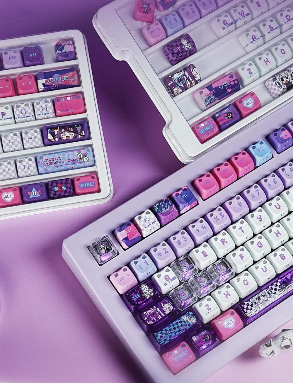 Yunyun Denpa keycaps arranged in storage trays beside a fitted mechanical keyboard