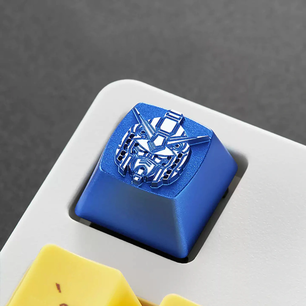 Angled close-up of a blue metal mecha head keycap in a white keyboard.