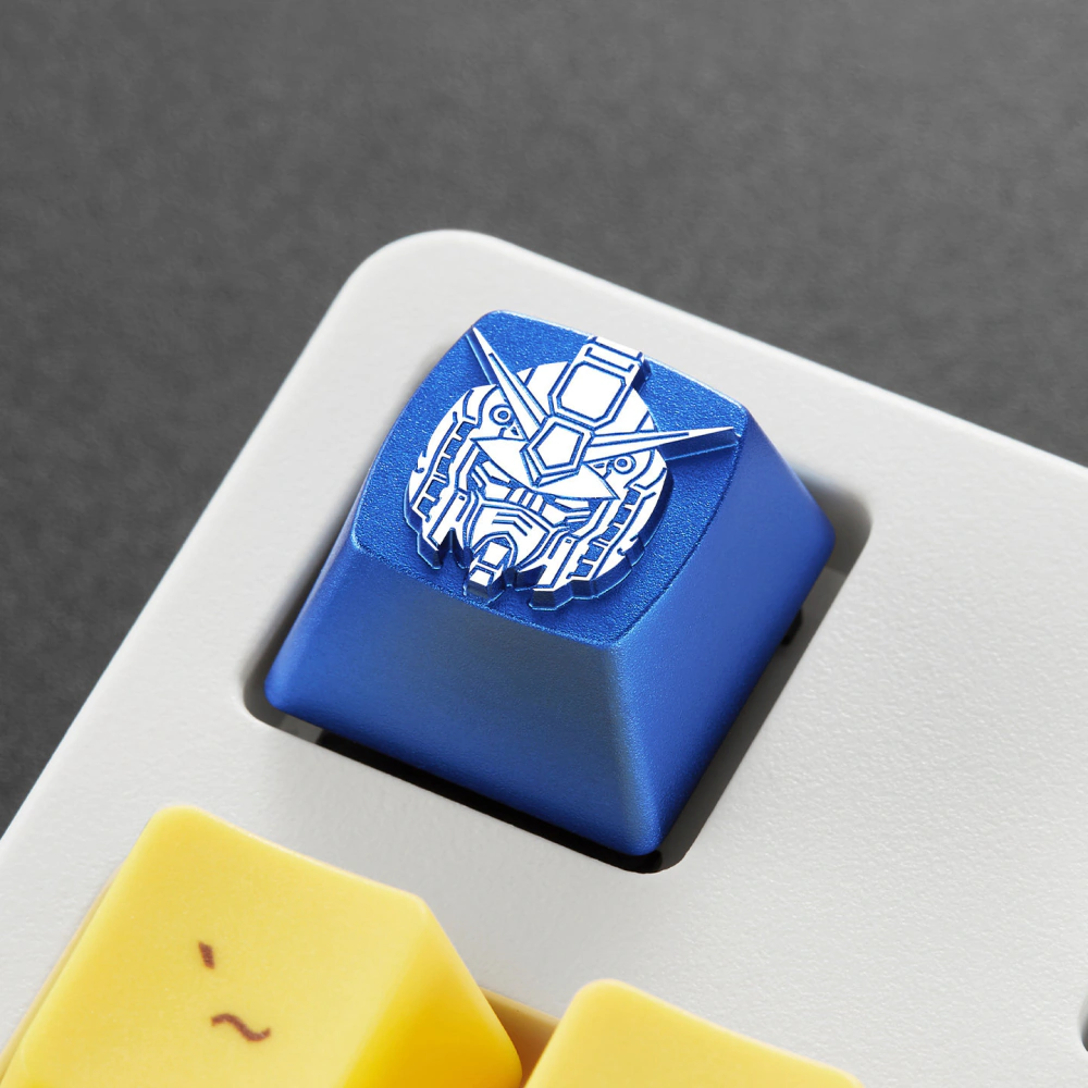 Angled top view of a blue metal mecha head keycap in a white keyboard.