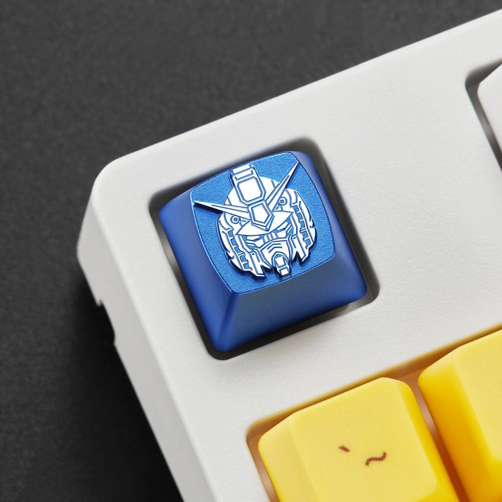 Blue metal mecha head keycap installed beside yellow keys on a white keyboard.