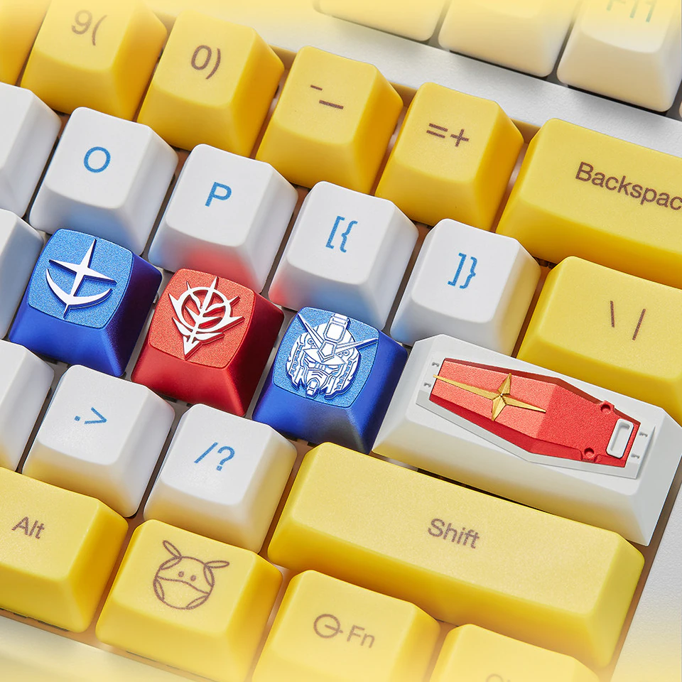 White and yellow keyboard with blue and red metal mecha keycaps and a red shield-shaped keycap.