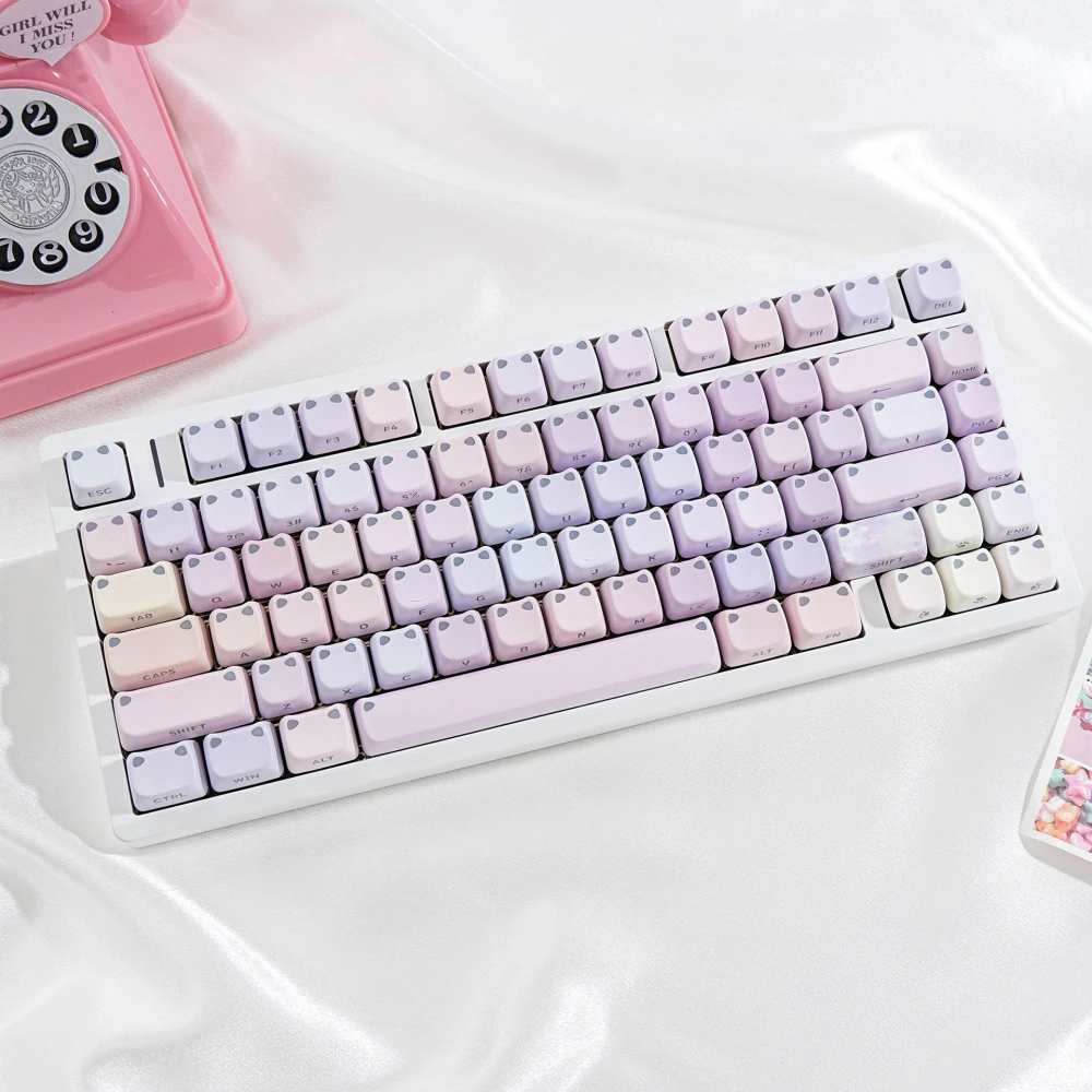 Rounded pastel keycaps with two raised cat-ear corners on each cap