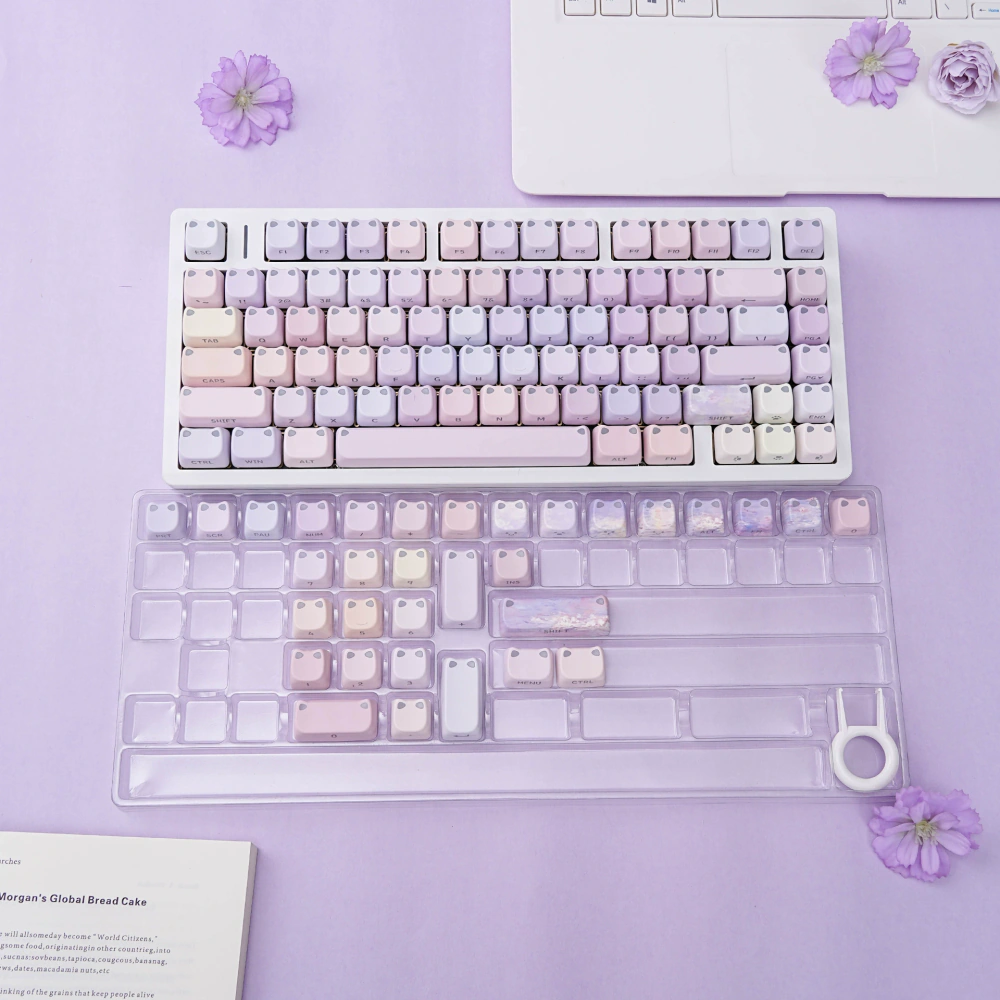 Complete pastel cat-ear keycap set with additional keys in a clear tray