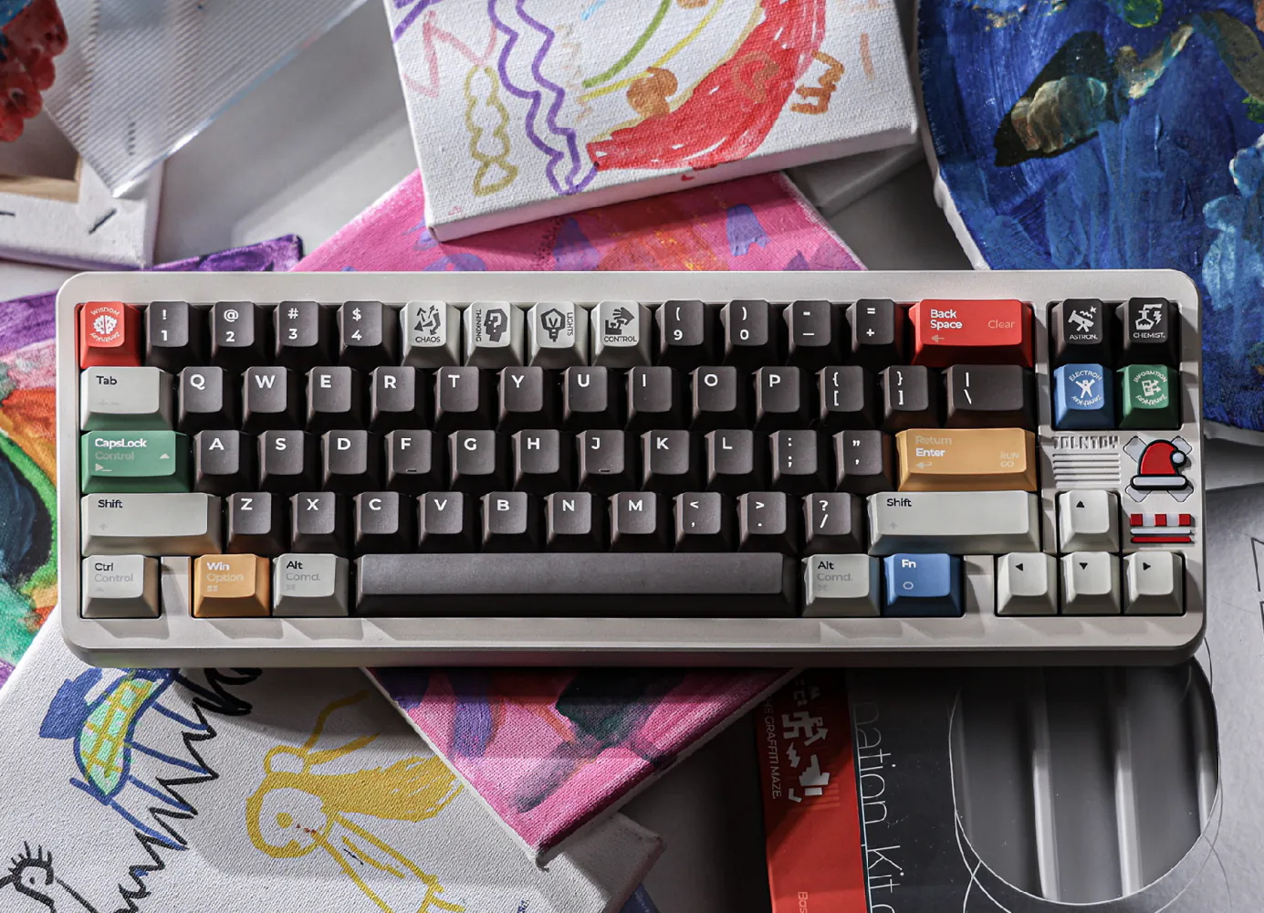 Angled keyboard with pale gray alphanumeric keys, charcoal modifiers, and colored accent keys.