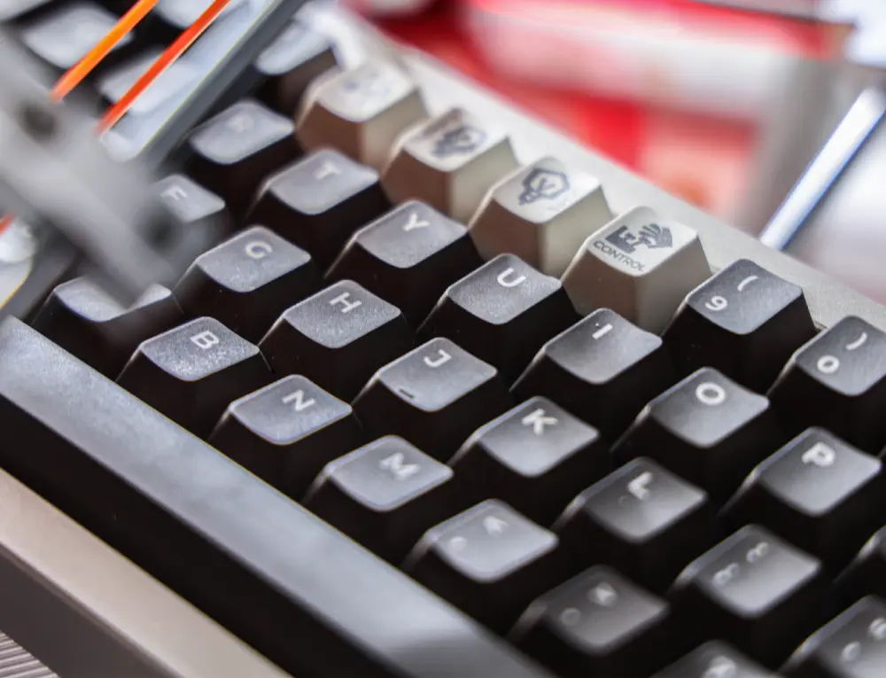 Close view of pale legends on gray key tops with dark sides between the keys.
