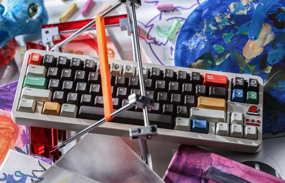 Keyboard displayed at an angle on a stand, with gray and dark keys and colored modifiers.