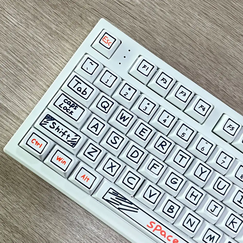 Left side of a white keyboard showing black outlined legends and orange modifier labels.