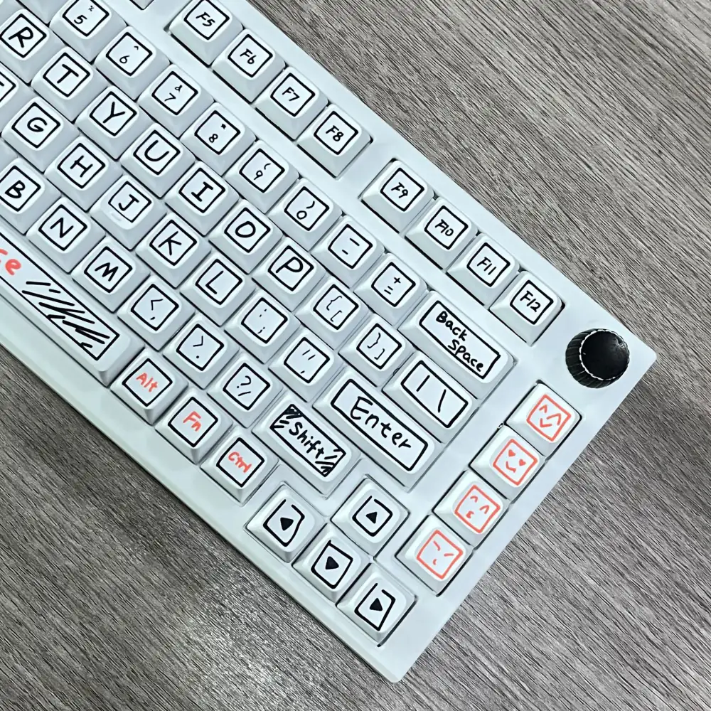 Right side of a white keyboard with outlined legends, arrow keys, and orange icon keys.