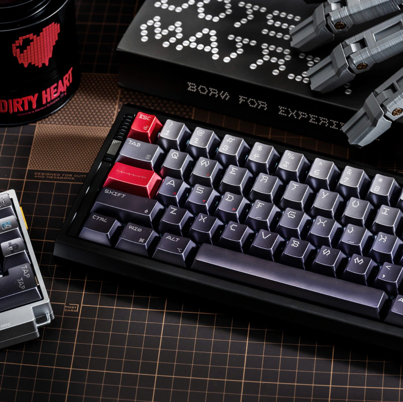 Silver keycaps sit above dark dot-matrix keys on a pale keyboard case.