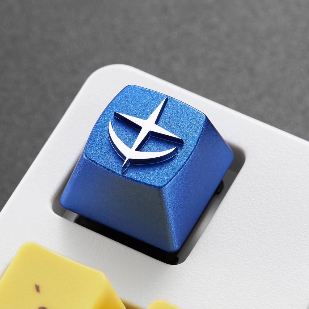 E.F.S.F. Emblem Aluminum Artisan Keycap Angled close-up of a blue E.F.S.F. emblem keycap on a white mechanical keyboard.
