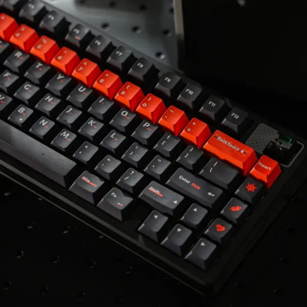 Elimination Protocol Obsidian Keyboard Cover Black keyboard with dark keycaps and an orange number row and accent keys.