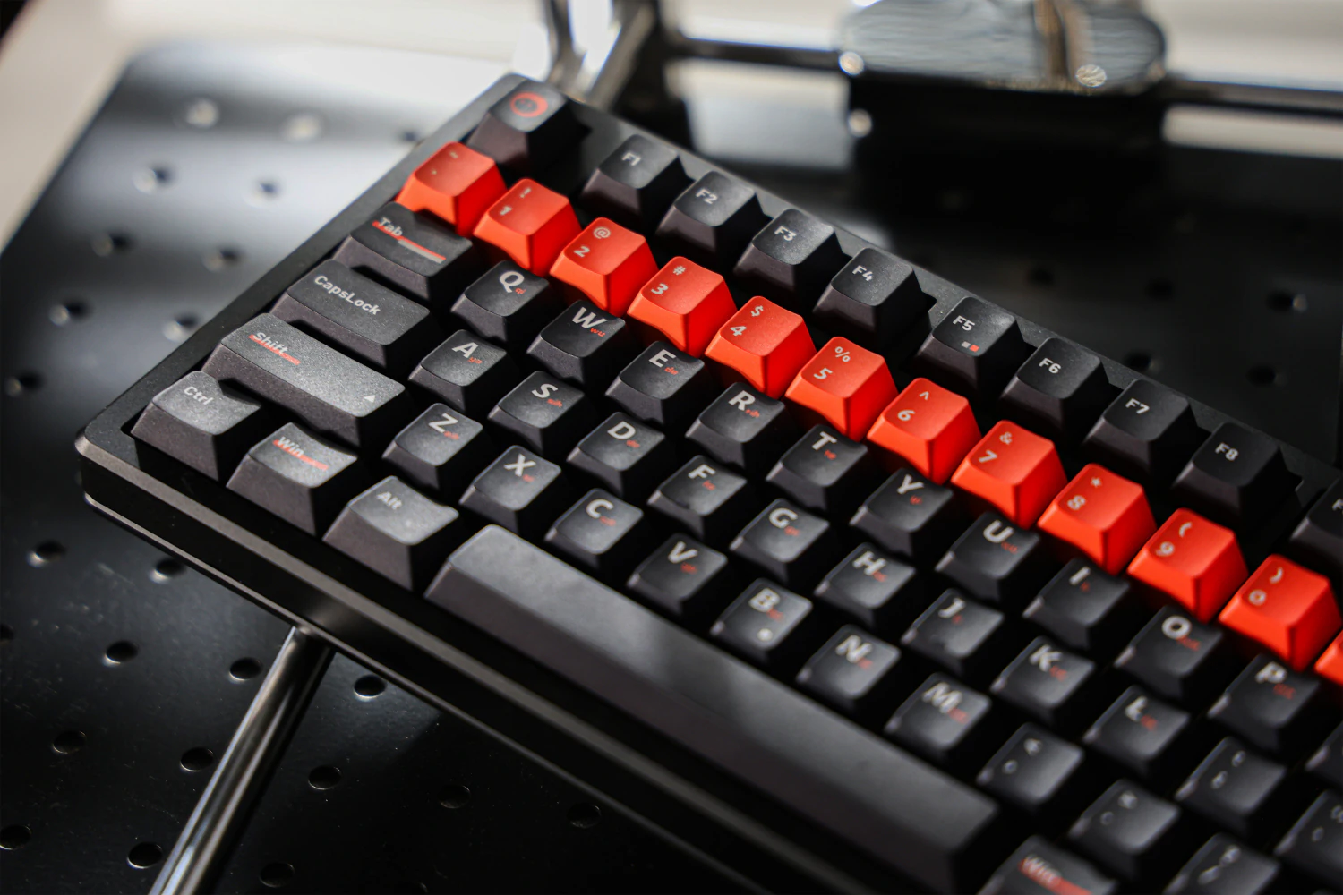 Rows of dark letter keys with white legends and small orange marks.
