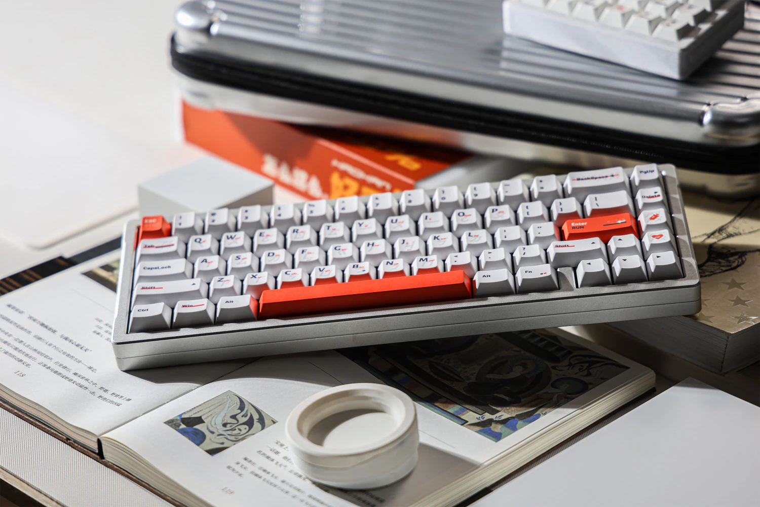 Full gray keyboard with white keycaps and orange accents, photographed at an angle.
