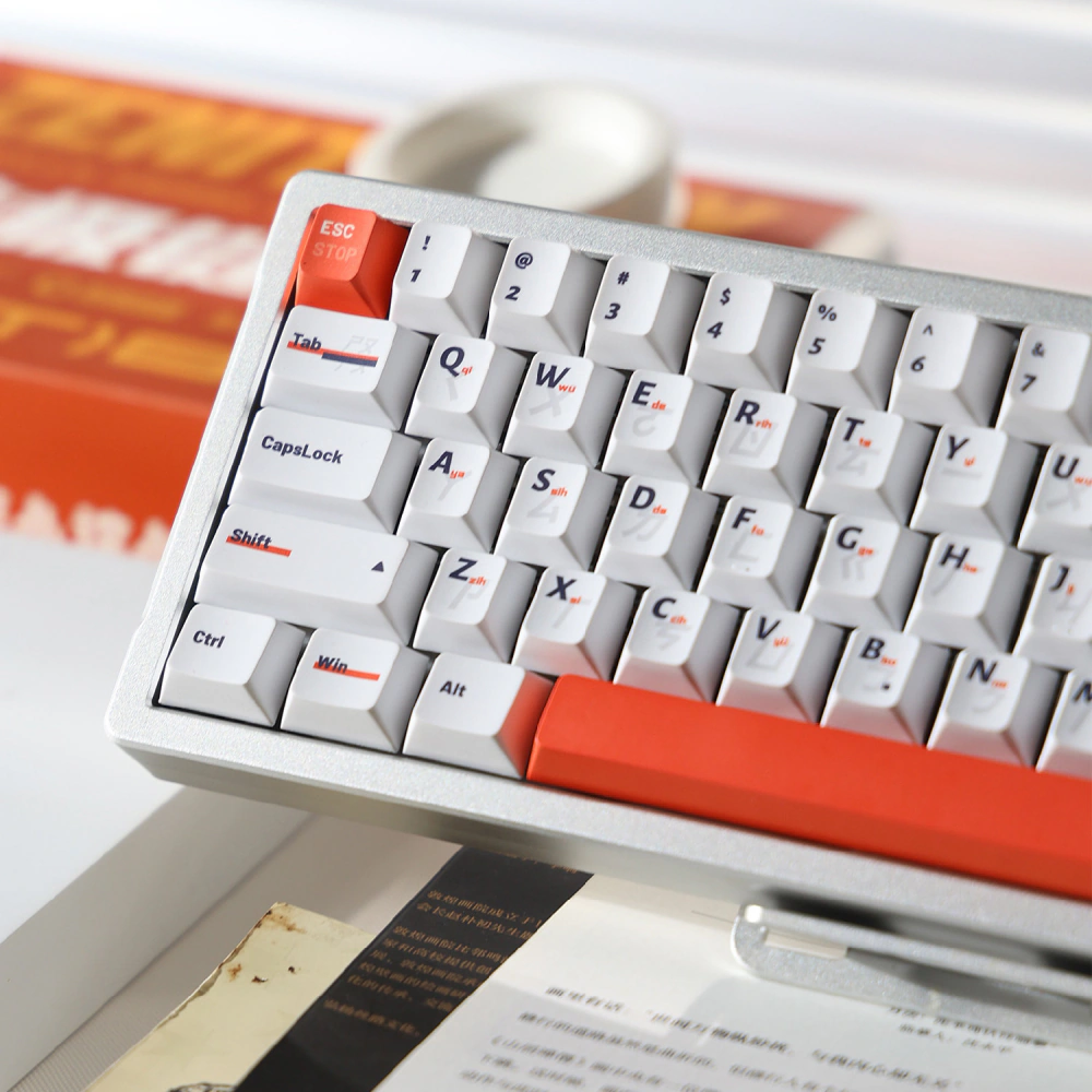 Left side of a white keyboard with orange number, Escape, and spacebar keys.