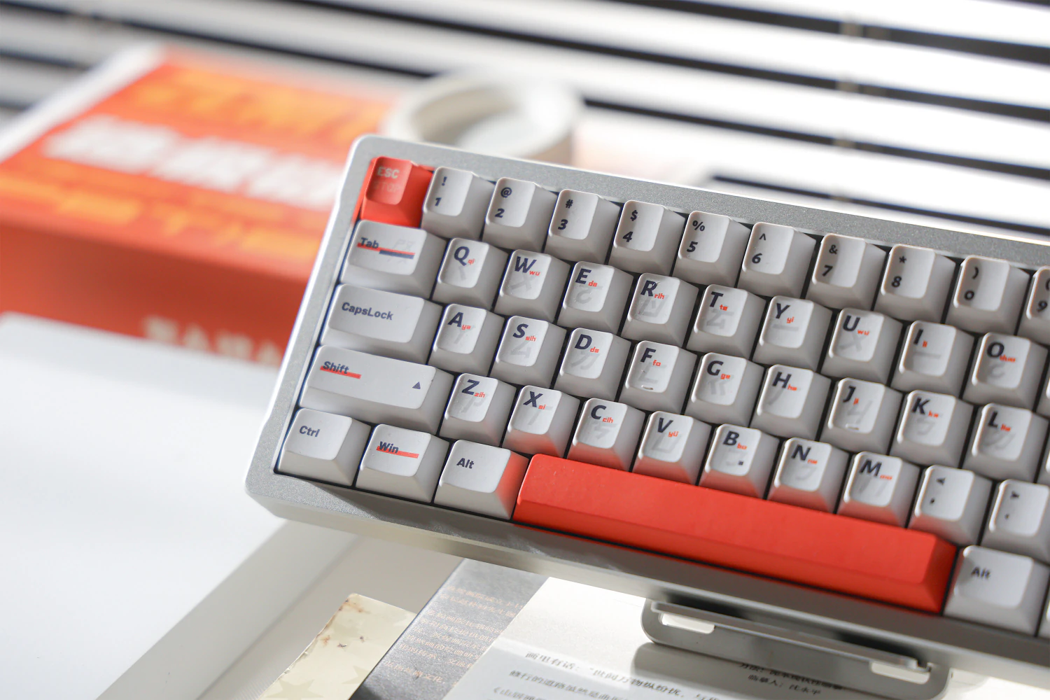 Rows of white letter keys with dark Latin legends and small orange marks.