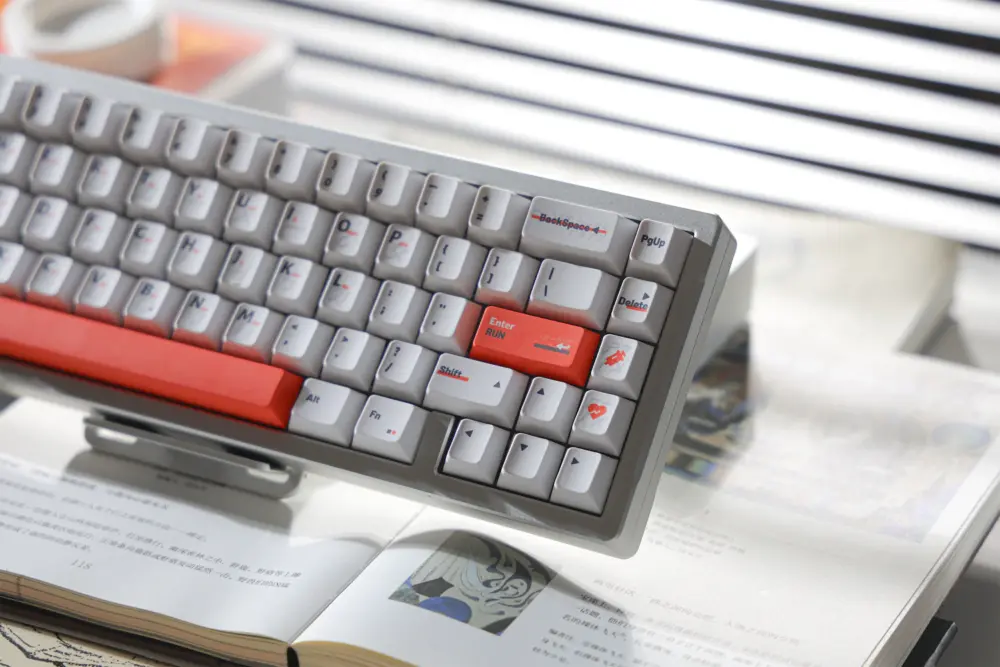 Right side of a white keyboard with an orange Enter key and gray navigation keys.