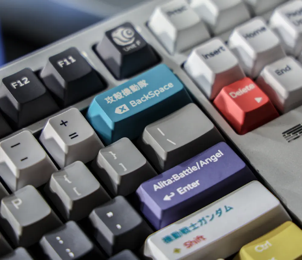 Close view of several labeled accent keys among gray keycaps.