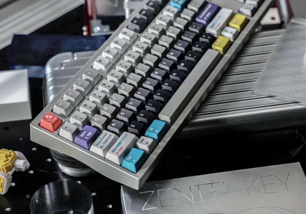 Keyboard shown diagonally with gray keycaps and a few colored keys.