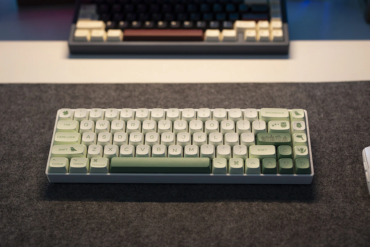 Green Botanical Keycaps Front Desk View Front view of a compact keyboard with green and white botanical and animal keycaps.