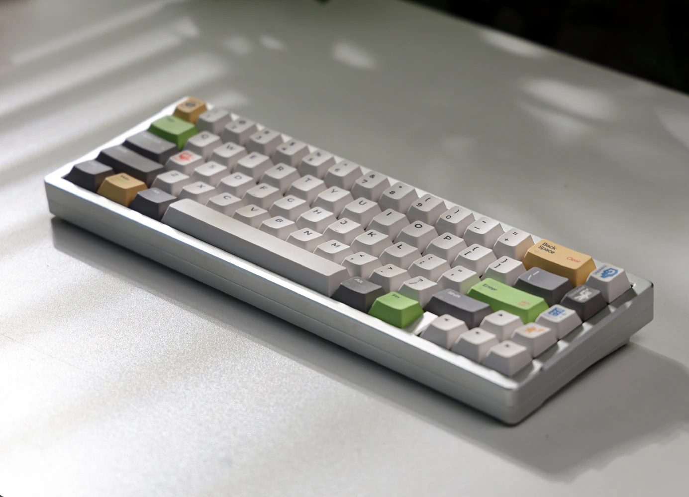 Light Graffiti Maze Description Keyboard Angled keyboard with light gray and off-white keys, dark gray modifiers, and green and yellow accents.