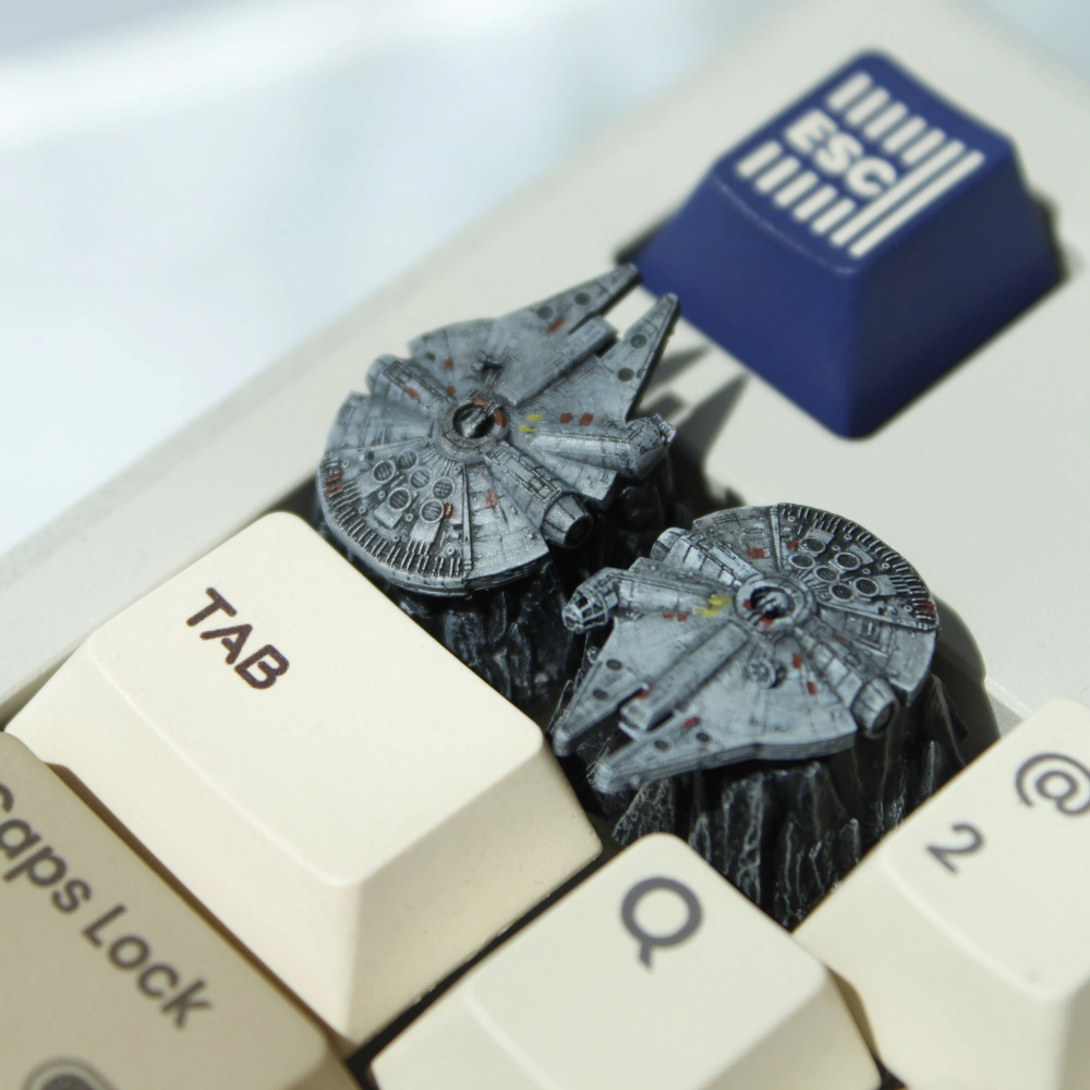 Two Millennium Falcon Keycaps on Keyboard Two detailed Millennium Falcon keycaps appear among keyboard keys, including a blue ESC key.
