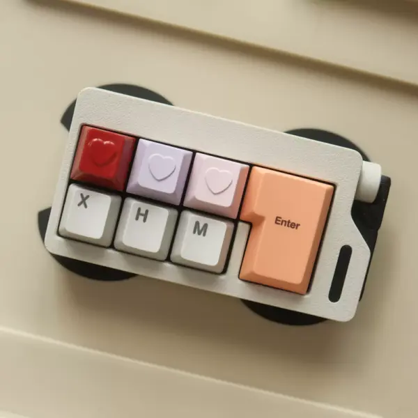 Minimal Heart-Shaped Metal Artisan Keycap Color Options Compact keyboard with red, lavender, and pink heart keycaps.