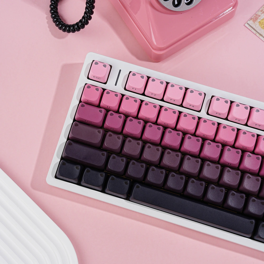 Close-up of rounded pink, purple, and black MAO profile keycaps