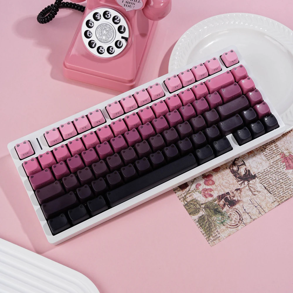 Angled keyboard view with pink-to-black gradient cat-ear keycaps